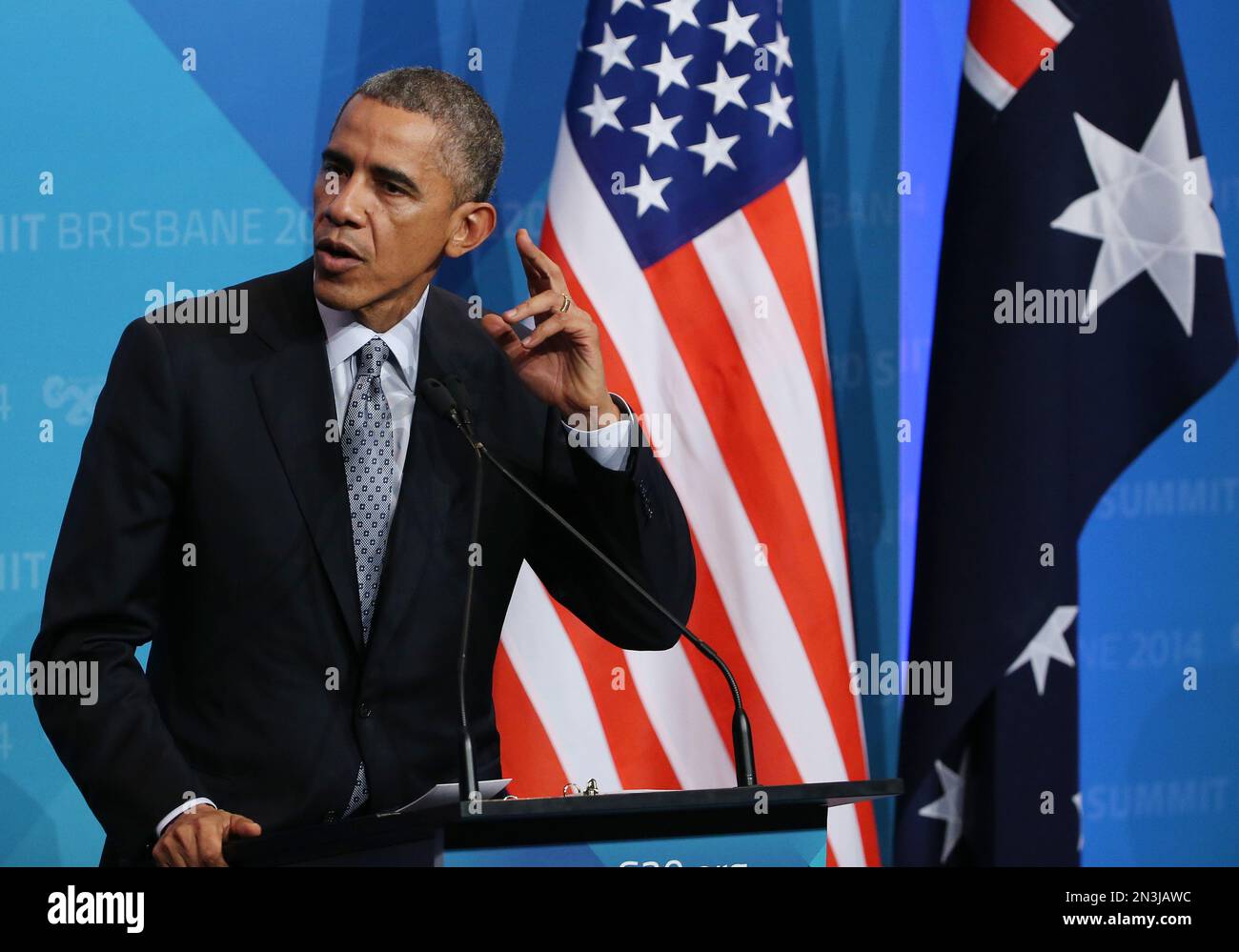 U.S. President Barak Obama gestures as he attempts to hear a question ...