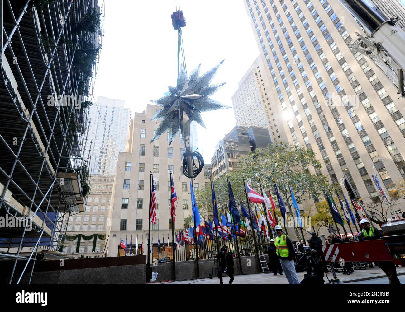 IMAGE DISTRIBUTED FOR SWAROVSKI Workers raise the Swarovski Star to the top of the 85foot
