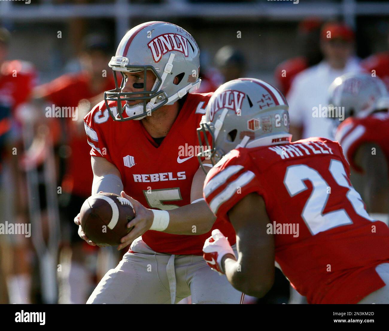 UNLV quarterback Blake Decker (5) hands off the ball to running back