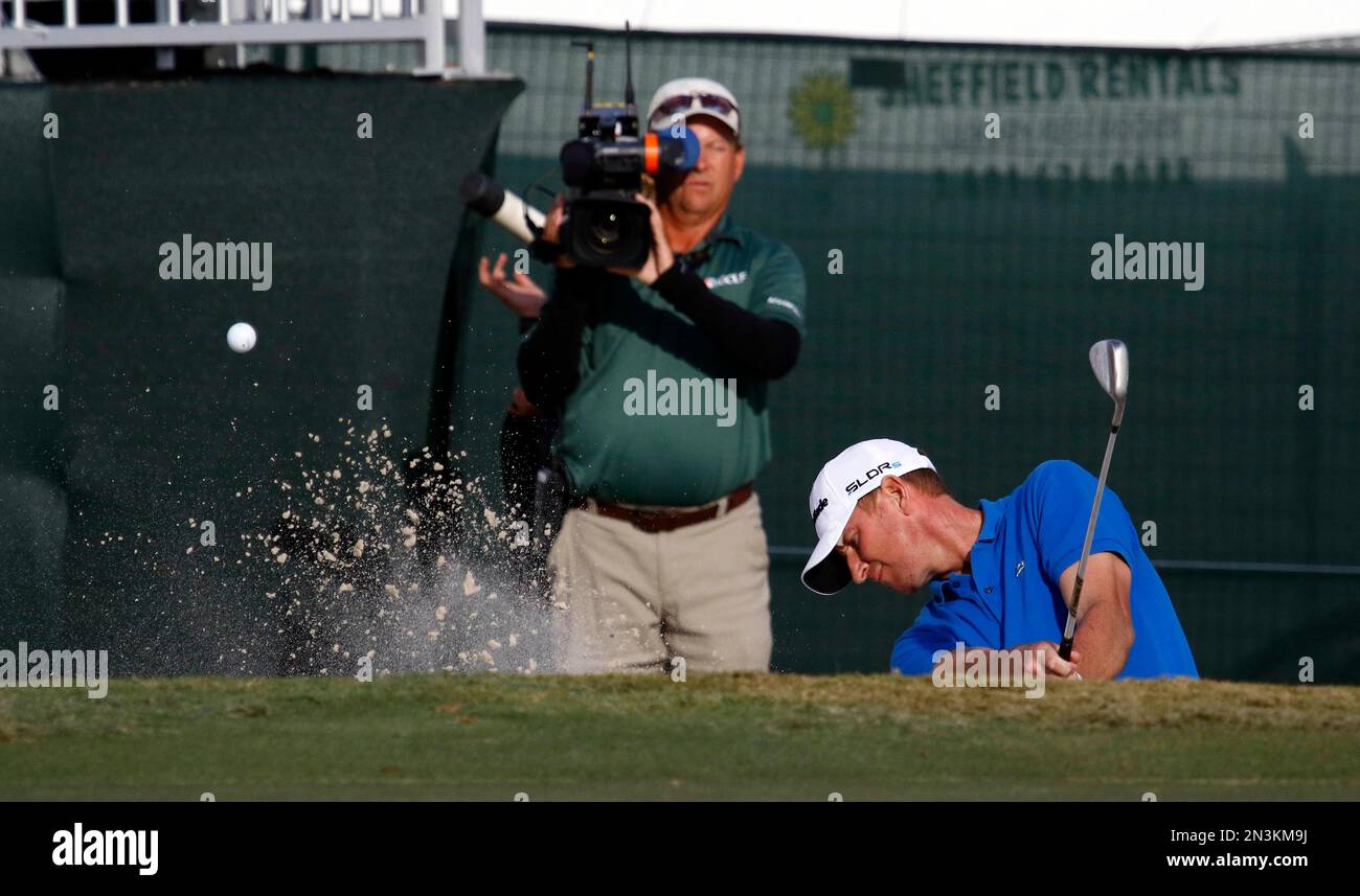 Vaughn Taylor hits out of the sand on the 17th hole during the third