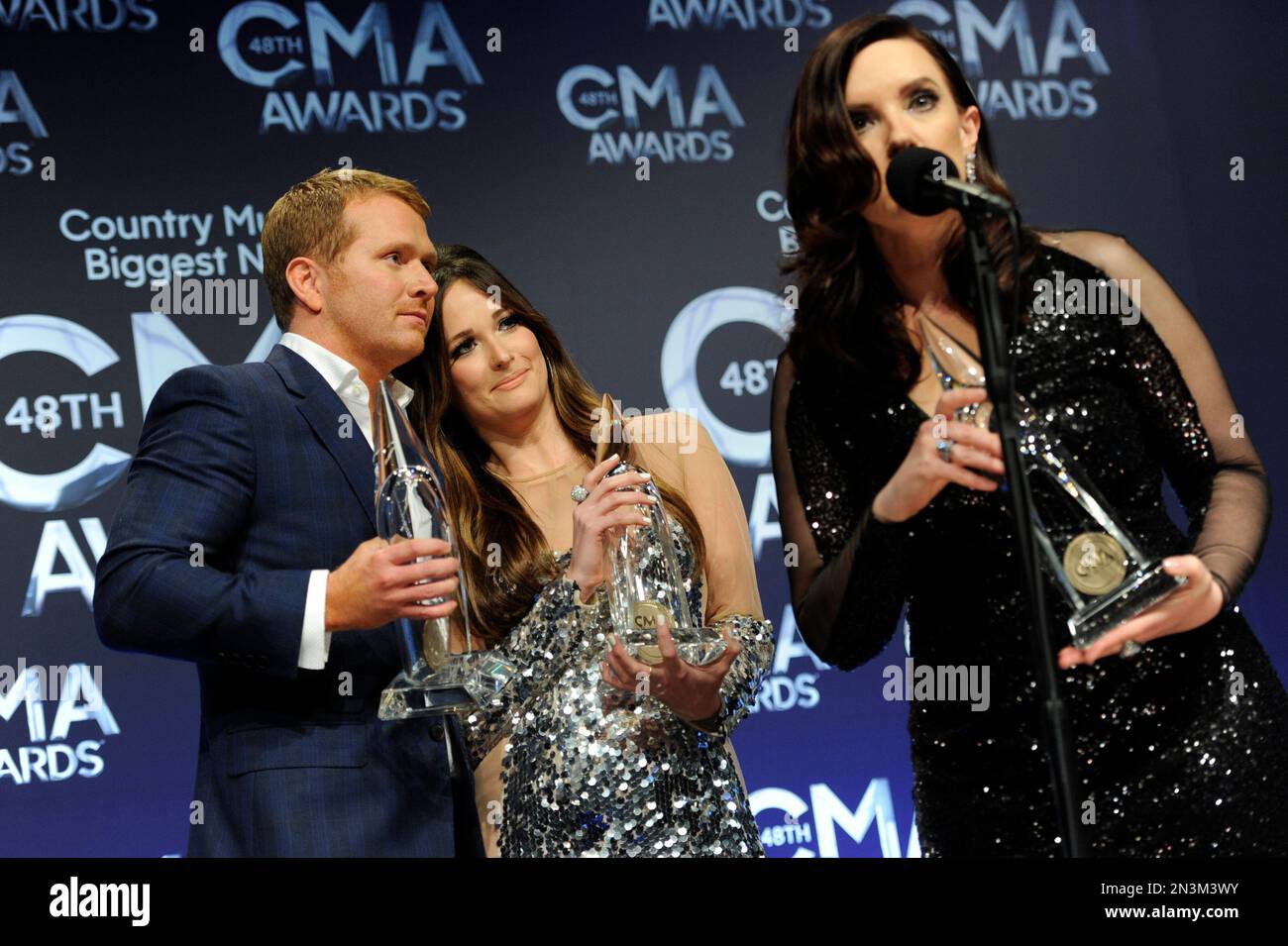 From left, Shane McAnally, Kacey Musgraves and Brandy Clark pose in the press room with the song