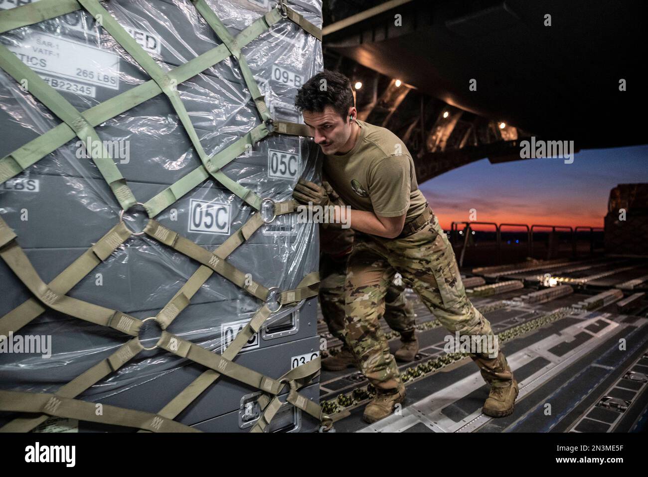 February 7, 2023, Dover Air Force Base, Delaware, USA: Senior Airman GARRETT LAMARCHE, 6th Airlift Squadron loadmaster, pushes a cargo pallet onto a C-17 Globemaster III at Dover Air Force Base. The U.S. Agency for International Development (USAID) is mobilizing emergency humanitarian assistance to respond to the devastating impacts following the worst earthquake to hit the region in almost a century. (Credit Image: © Marco Gomez/U.S. Air Force via ZUMA Press Wire Service) EDITORIAL USAGE ONLY! Not for Commercial USAGE! Stock Photo