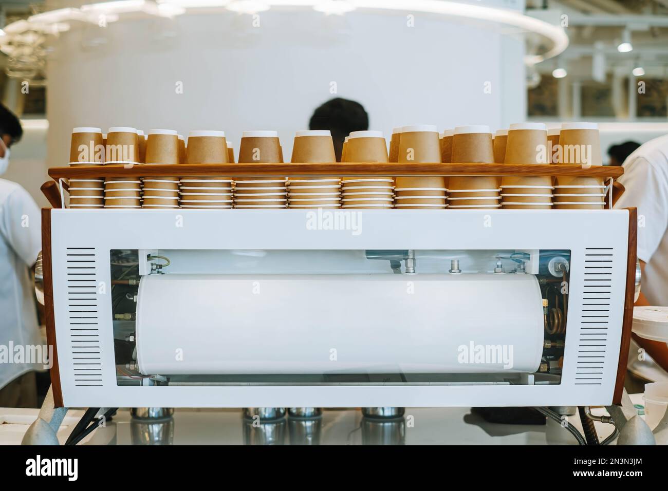 https://c8.alamy.com/comp/2N3N3JM/upside-down-disposable-cardboard-cups-on-espresso-machine-with-bokeh-background-2N3N3JM.jpg