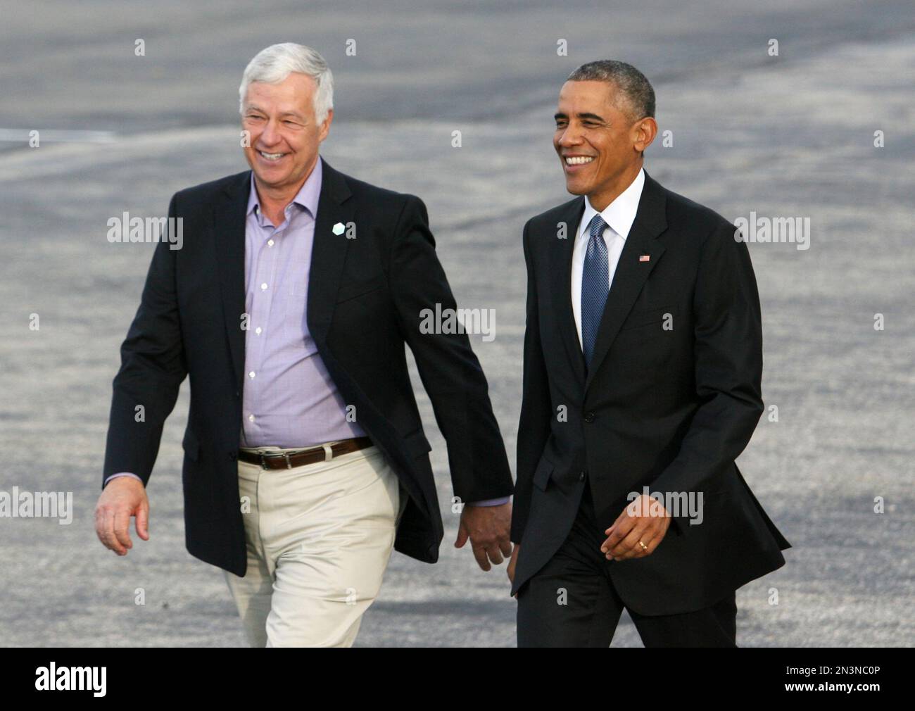 President Barack Obama walks across the tarmac with Maine Democratic ...