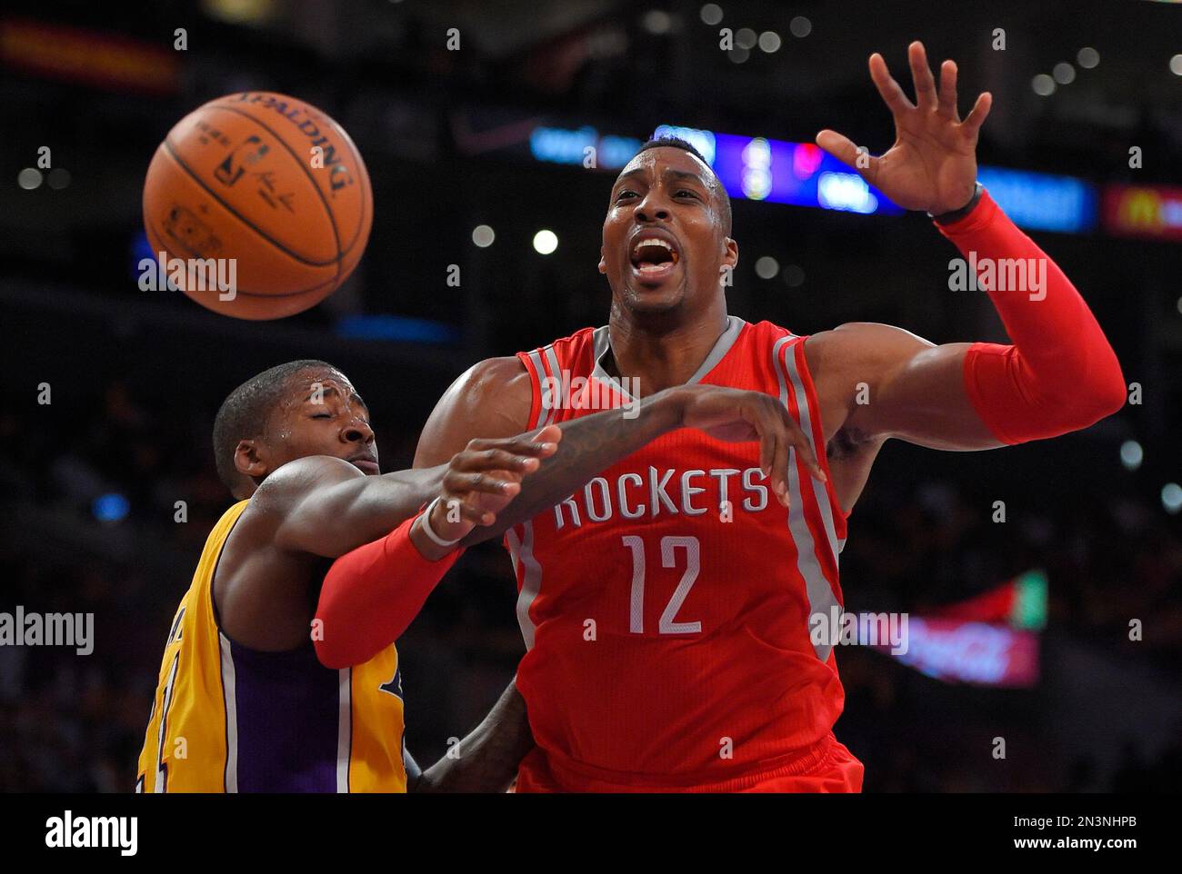 Los Angeles Lakers forward Ed Davis, left, fouls Houston Rockets center Dwight Howard during the second half of an NBA basketball game, Tuesday, Oct. 28, 2014, in Los Angeles. The Rockets won 108-90. (AP Photo/Mark J. Terrill) Stock Photo