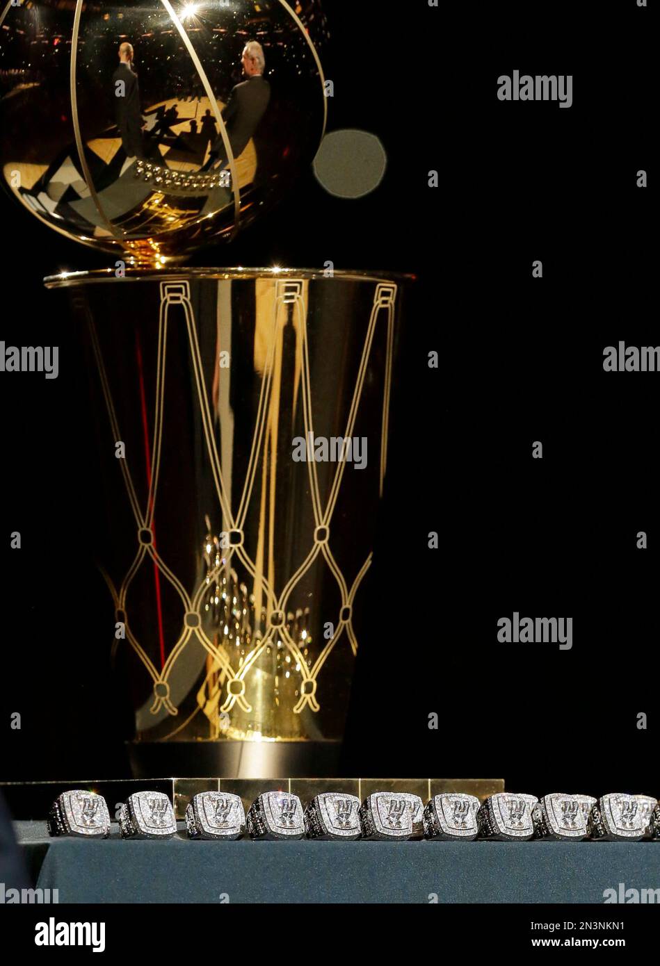 The San Antonio Spurs championship rings are lined up in front to the Larry  O'Brian trophy for a ring ceremony prior to an NBA basketball game between  the Spurs and the Dallas