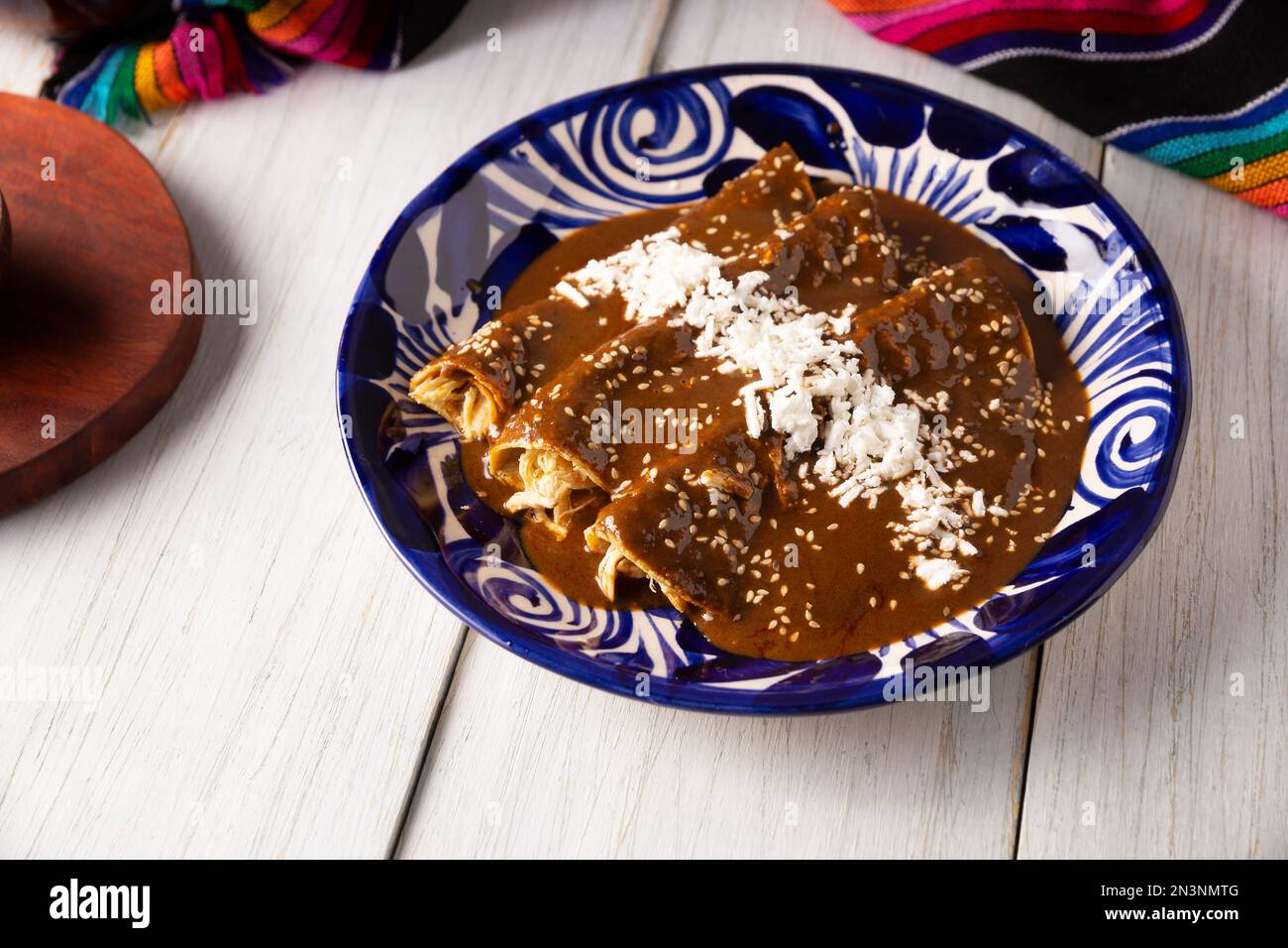 Chicken enmoladas. Also known as mole poblano enchiladas, they are a typical Mexican dish that is very popular in Mexico and the rest of the world. Stock Photo
