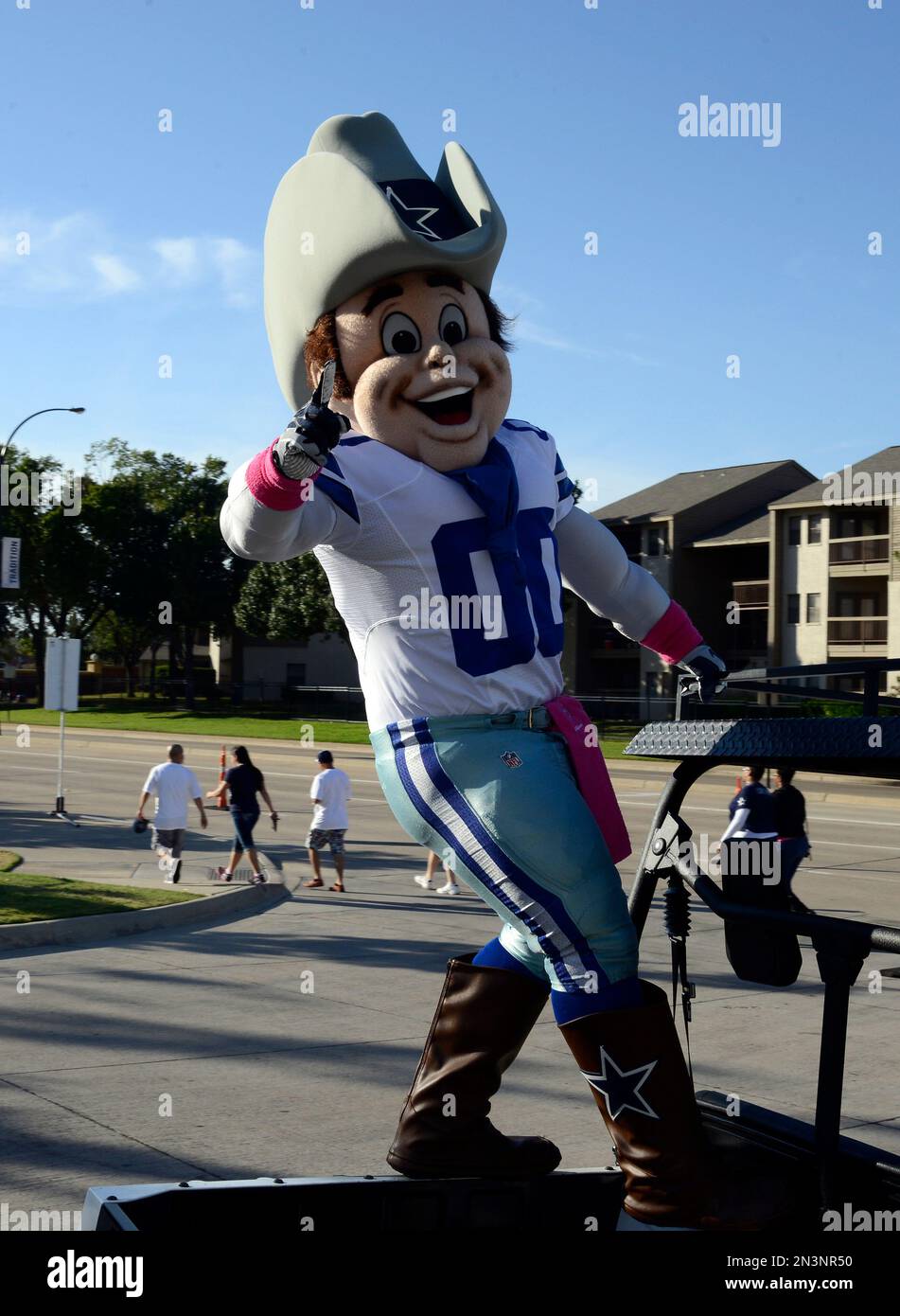 Dallas Cowboys mascot Rowdy rides on the back of a cart as