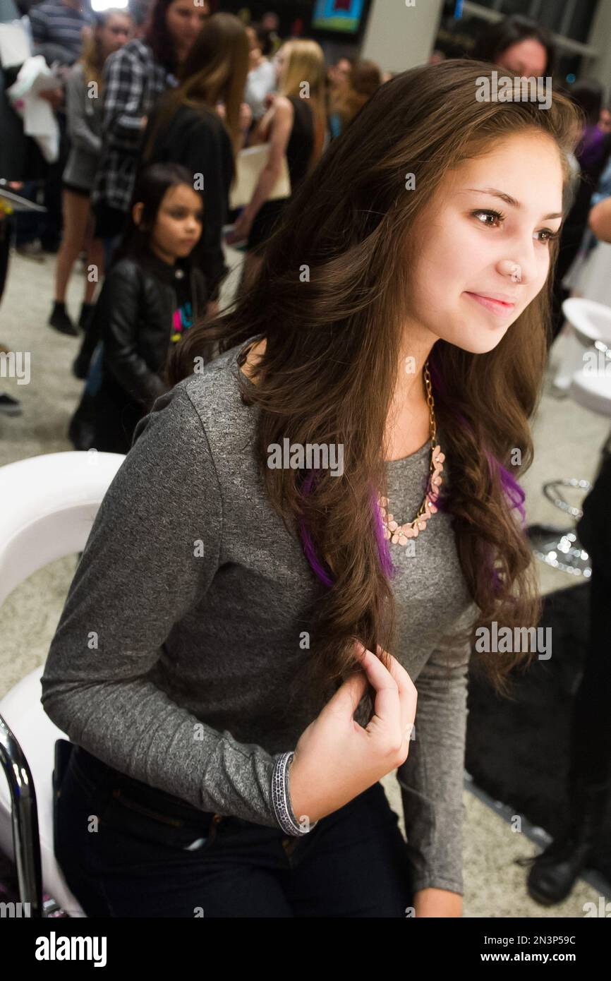 IMAGE DISTRIBUTED FOR SECRET COLOR - A Demi Lovato fan admires hair  extensions she had added at the Secret Color Salon during the Demi Lovato  World Tour on Saturday, Oct. 25, 2014