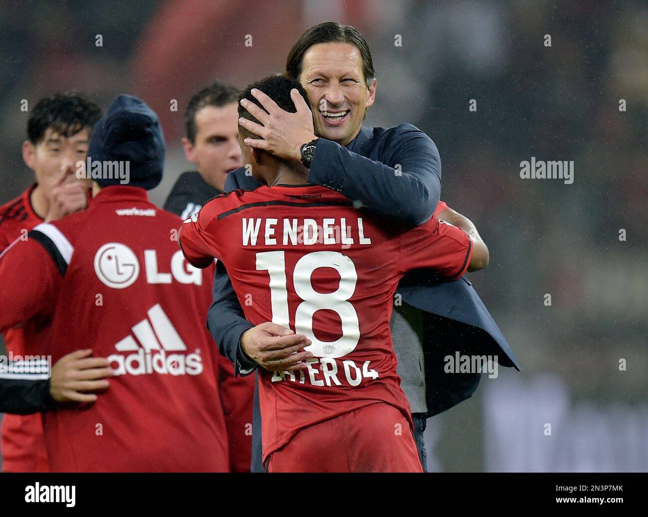 Leverkusen's head coach Roger Schmidt, center right, embraces Leverkusen's  Tin Jedvaj after the Champions League group C soccer match between Bayer 04  Leverkusen and Zenit in Leverkusen, Germany, Wednesday, Oct. 22, 2014.(AP