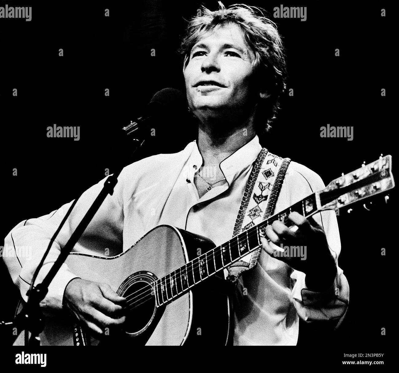 FILE - In this July 28, 1983 file photo singer John Denver strums his ...