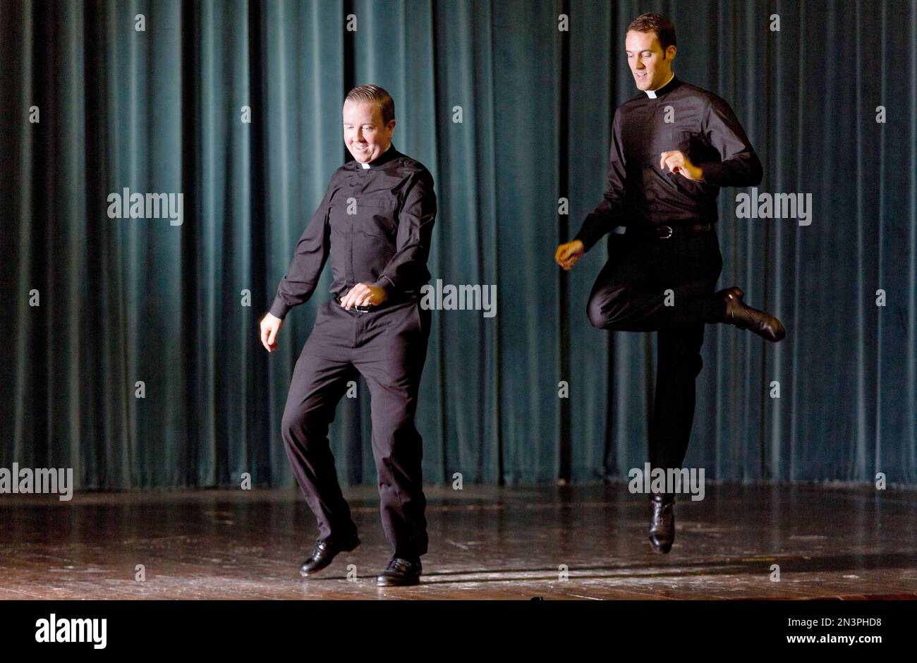 Father David Rider, left, and father John Gibson dance before an ...