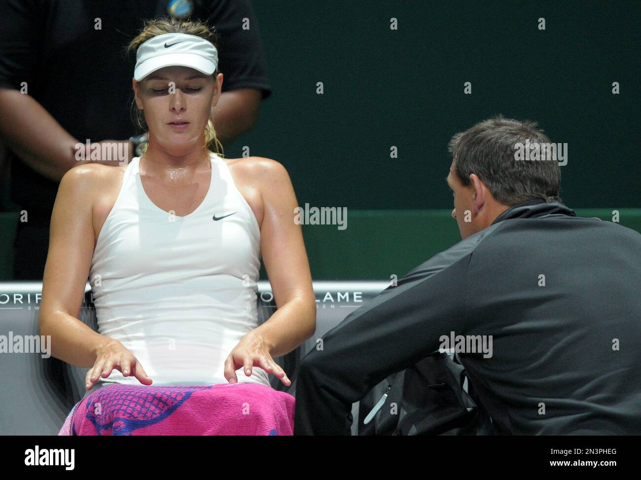 Russia's Maria Sharapova listens to her coach Sven Groeneveld during a  break in her singles match against Petra Kvitova of the Czech Republic at  the WTA tennis finals in Singapore, Thursday, Oct.