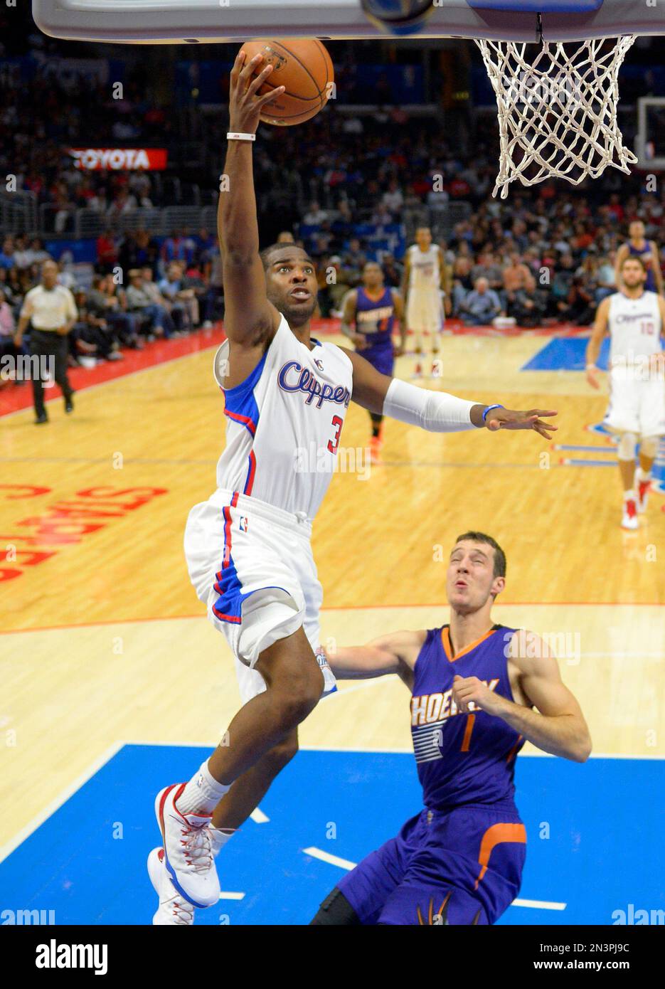 Los Angeles Clippers guard Chris Paul, left, puts up a shot as Phoenix