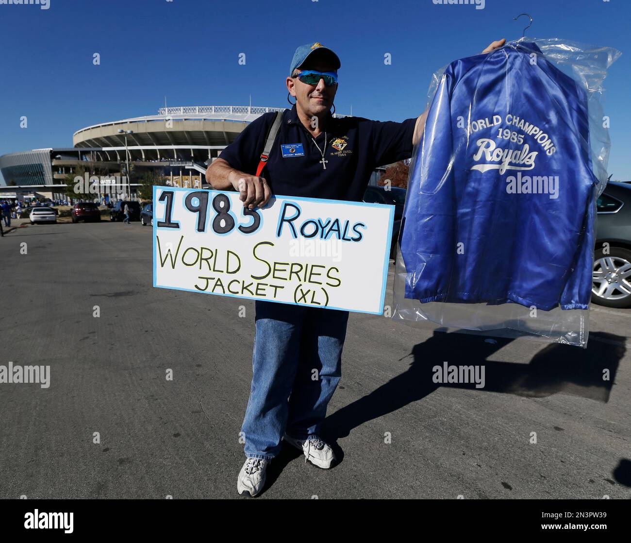 Anthony Warner, from Kansas City, holds up a 1985 Kansas City Royals jacket  from the 1985 World Series outside of Kauffman Stadium before Game 1 of  baseball's World Series between the Kansas