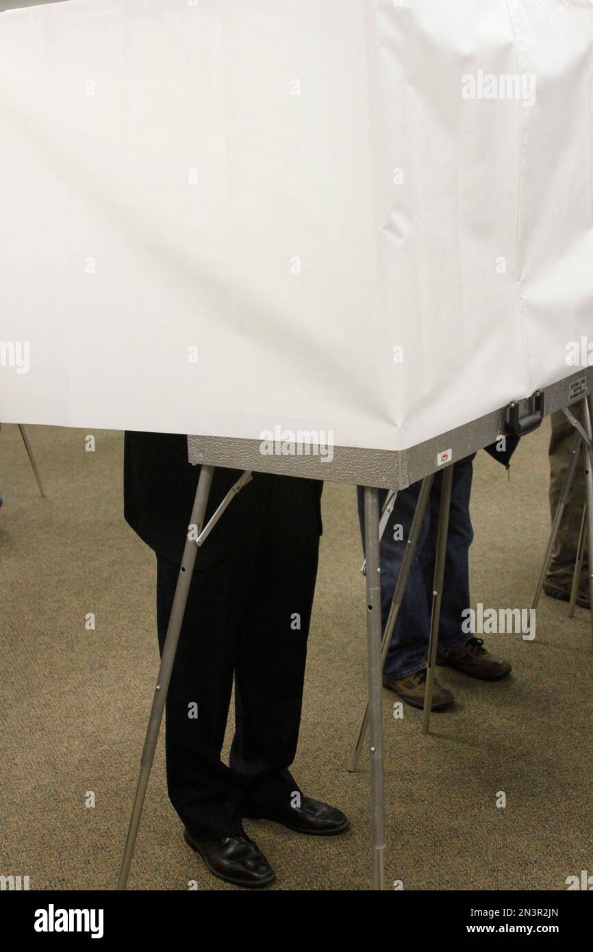 U.S. Sen. Mark Begich, DAlaska, left, casts his ballot at an early