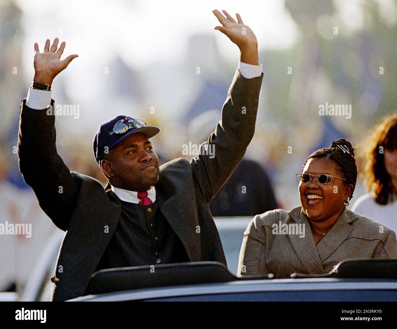 San Diego Padres great Tony Gwynn waves to the crowd as his wife, high  school sweetheart Alicia Gwynn looks on during the Padres' post World  Series parade in downtown San Diego in