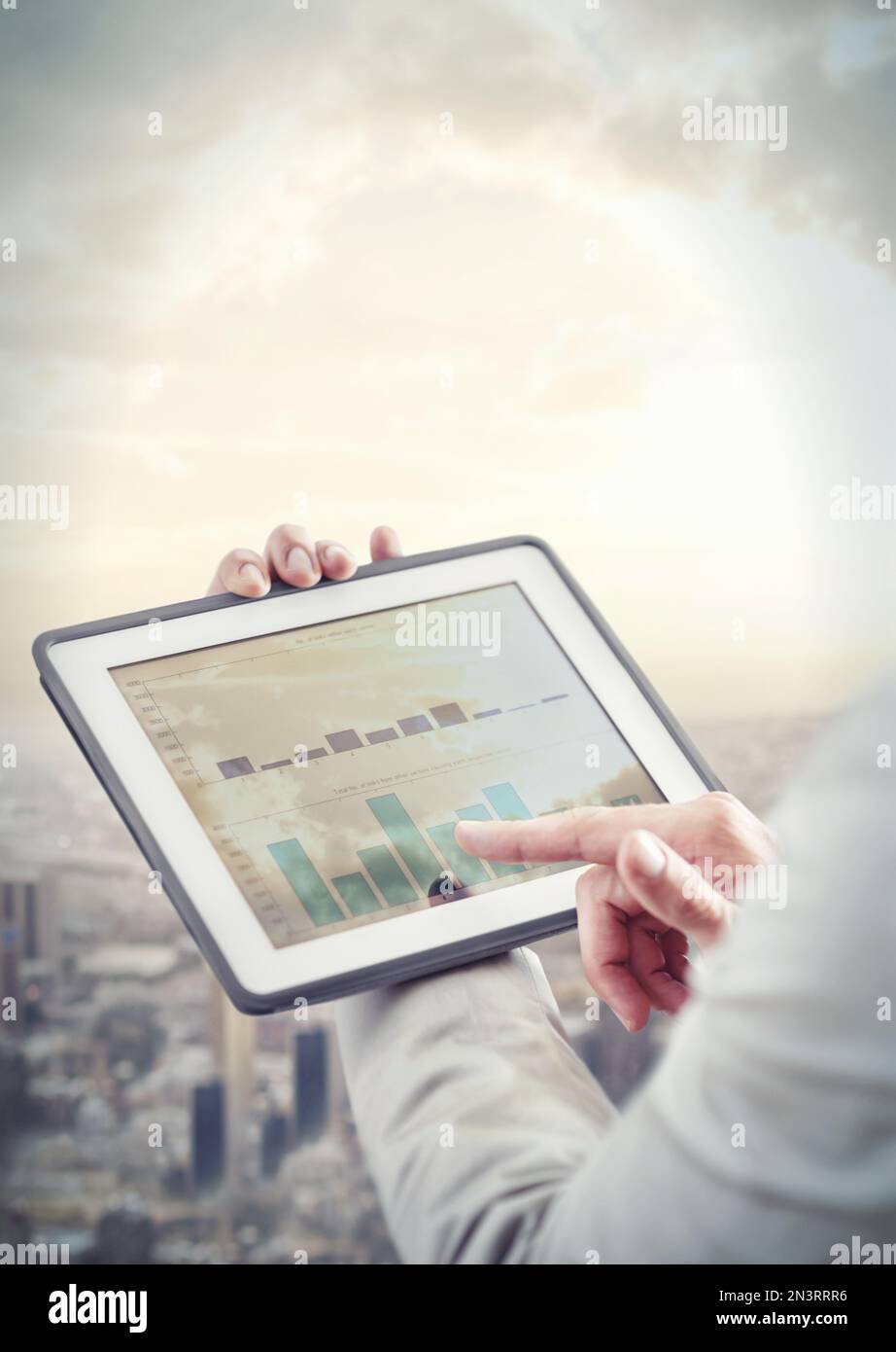 Working in a digital age. Cropped image of a businessman using a digital tablet. Stock Photo