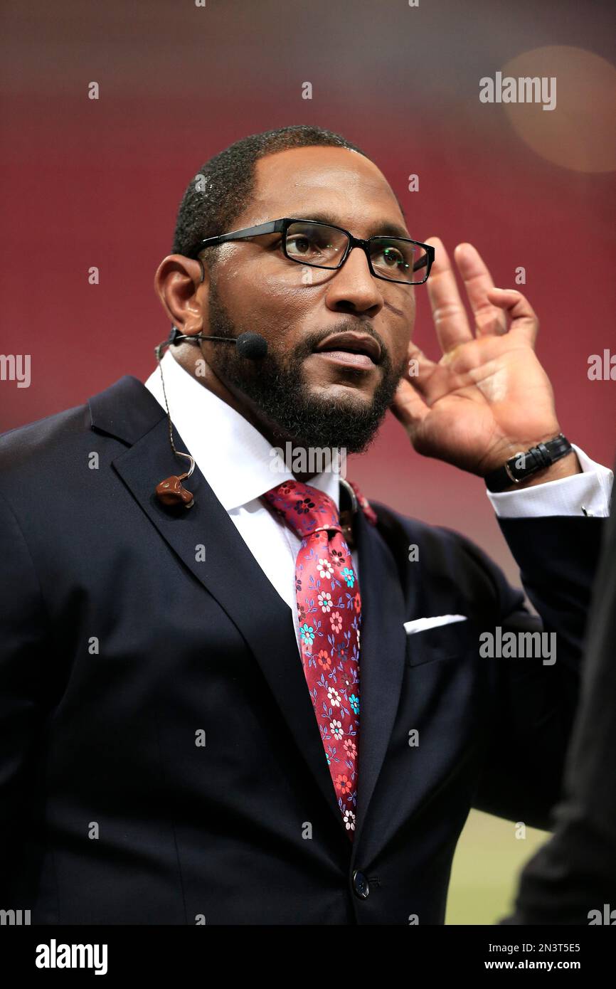 Former Baltimore Raven, Ray Lewis poses with his bust after his