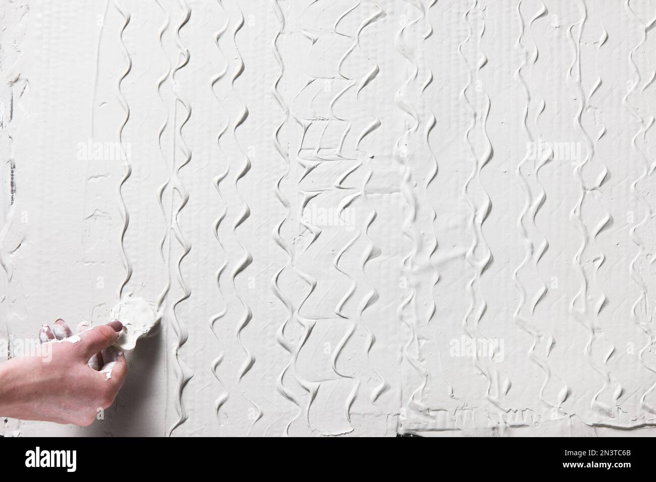 Photo inspiration: Visual Reference: Decorative Plaster Hand With Spatula Make Pattern Stock Photo