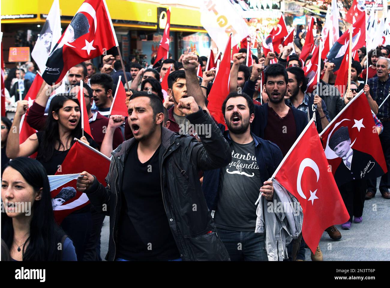 Several hundred members of the Youth Union of Turkey carry posters of ...