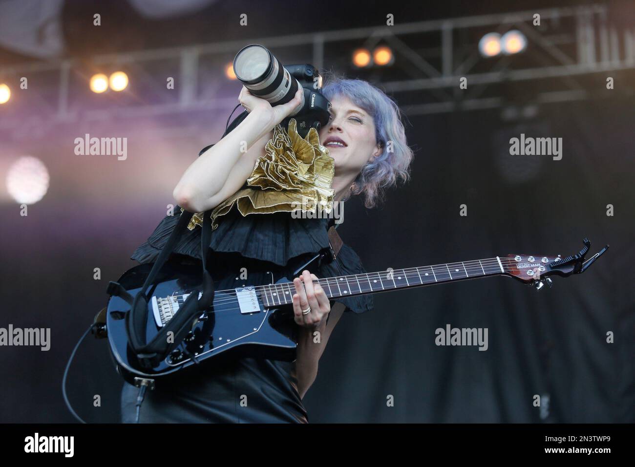 St. Vincent uses a camera as a prop during her performance at the