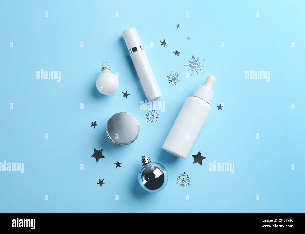 Flat lay composition with different cosmetic products on light blue ...