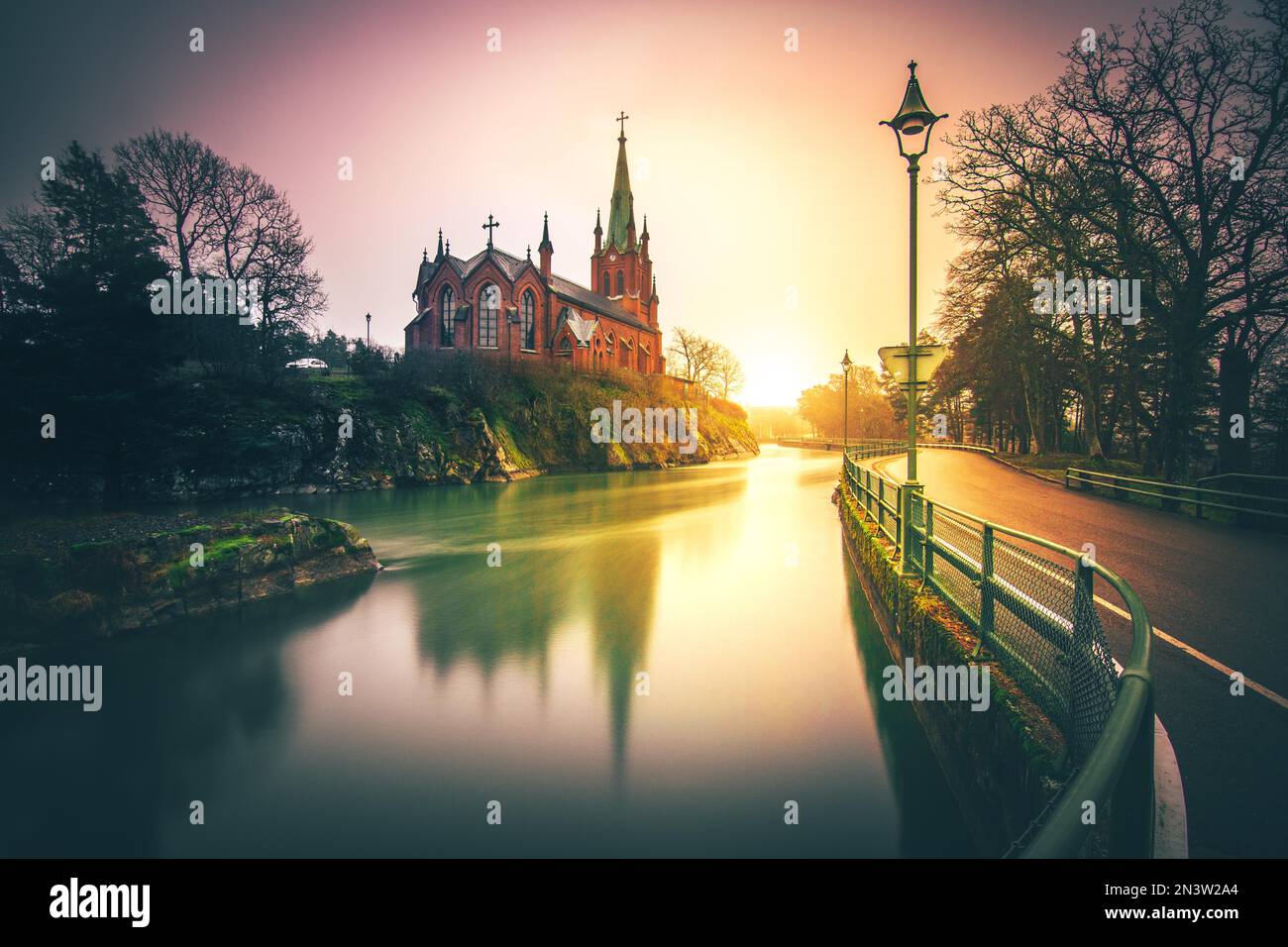 Trollhaettan, neo-Gothic church by the waterworks in the middle of the river, sunset, southern Sweden, Sweden Stock Photo
