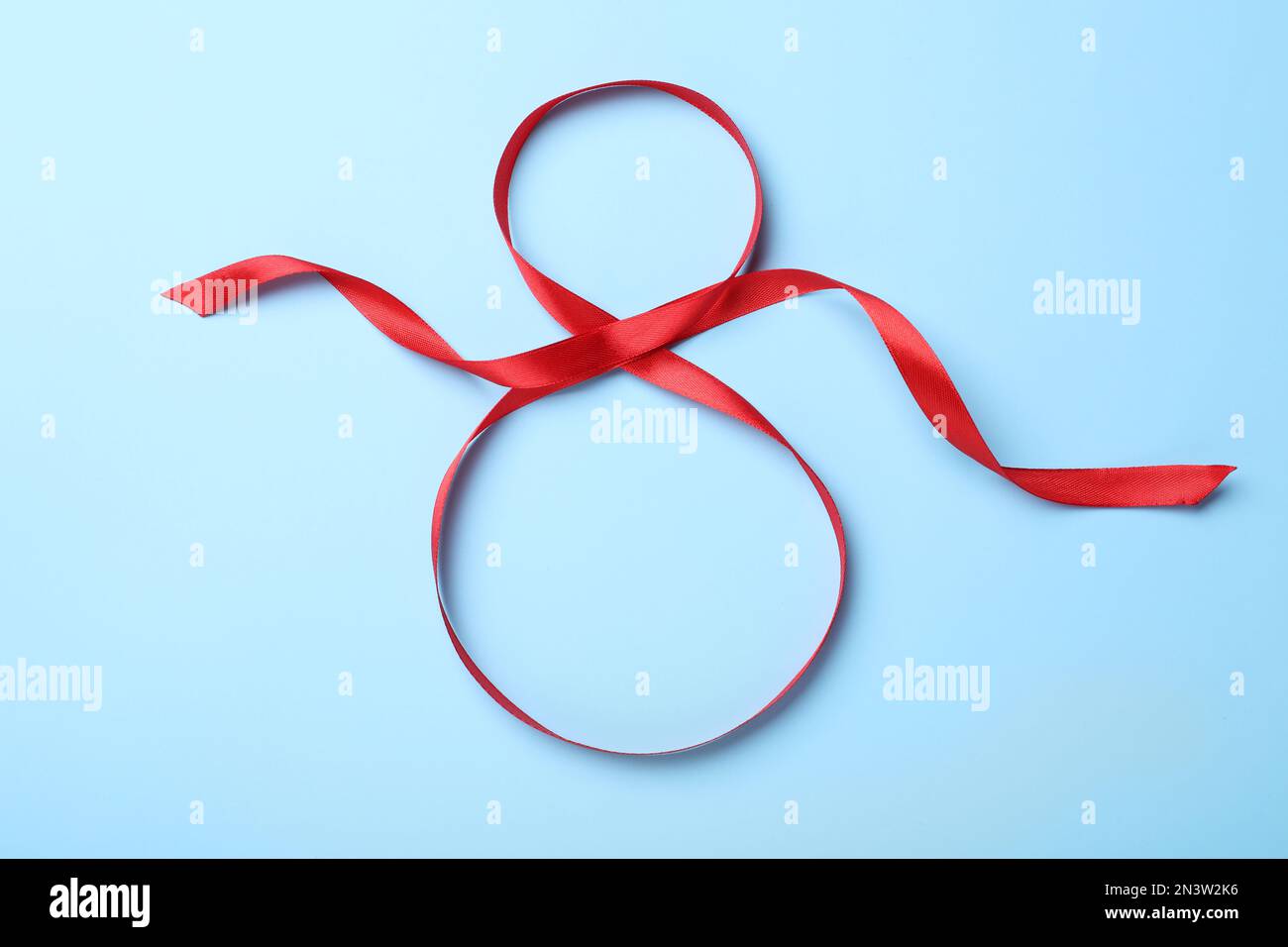 Red Ribbon 8 Number 8 of red ribbon on light blue background, top view ...