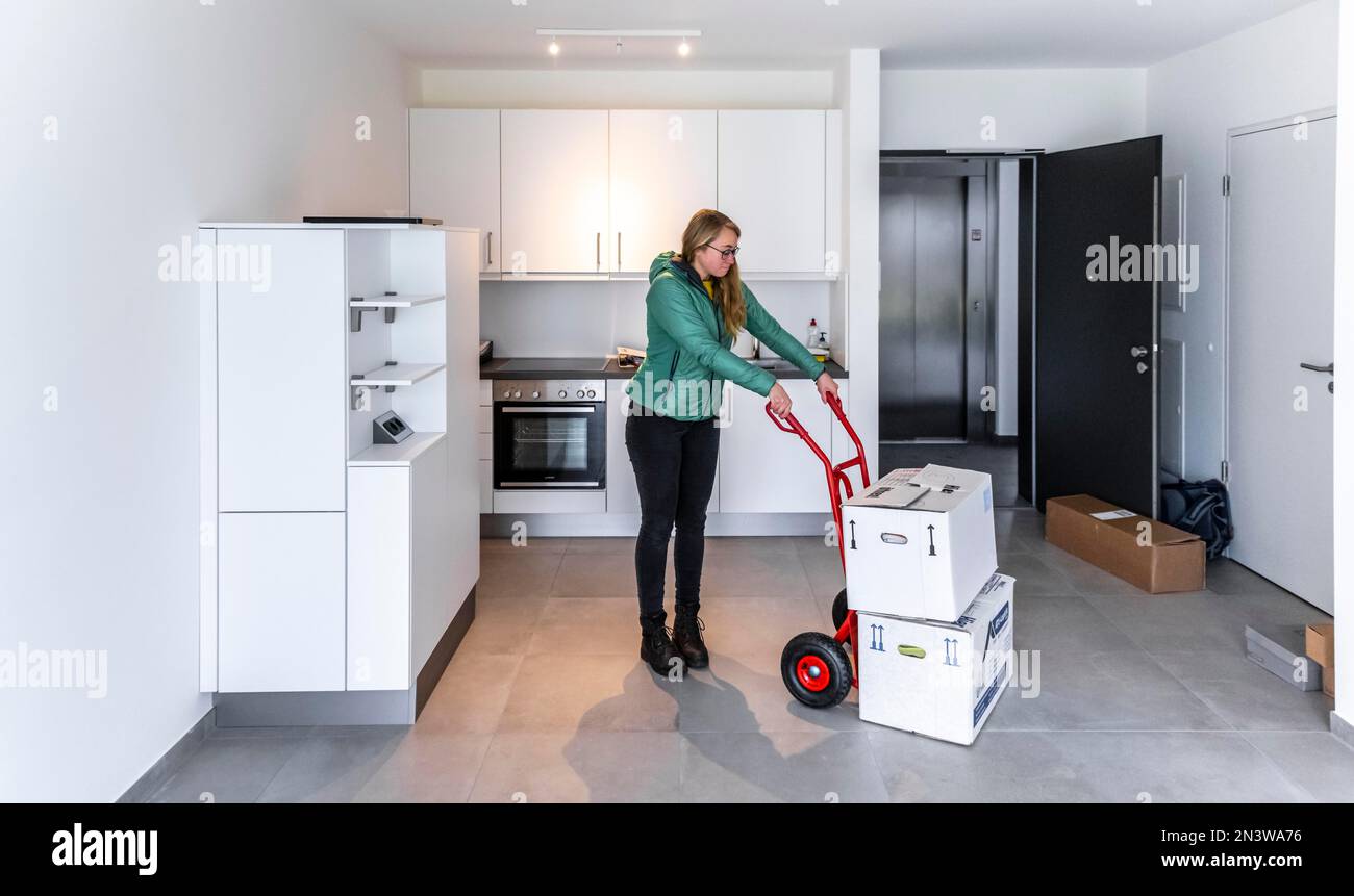 Young woman moves into an empty flat, flat move, Germany Stock Photo