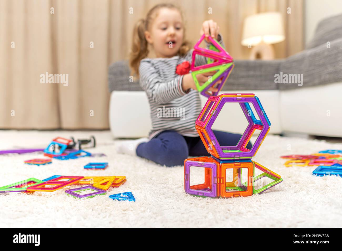 Child plays with a magnetic construction set Stock Photo - Alamy
