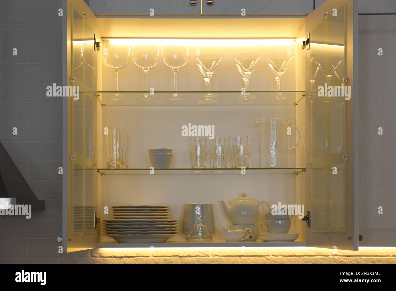 with crockery and glassware. Order in kitchen Stock Photo Alamy