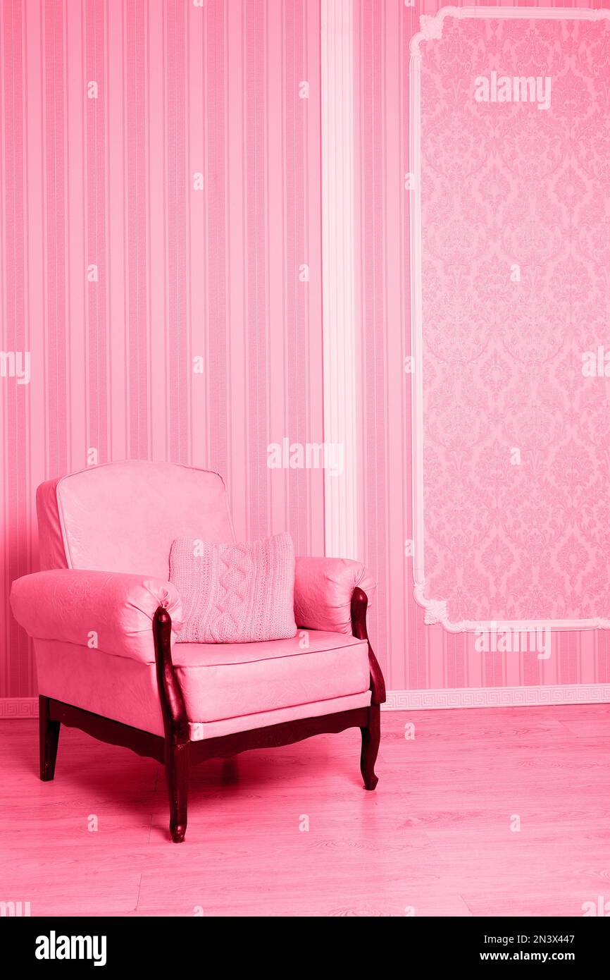 Vintage armchair on a background of wall Stock Photo - Alamy