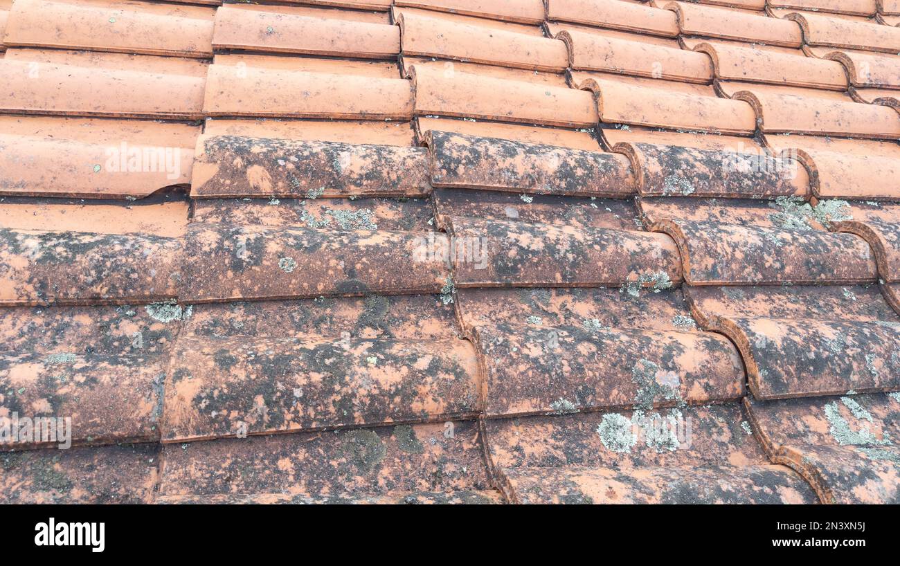 Roof cleaning tiles with high pressure cleaner and before after Stock