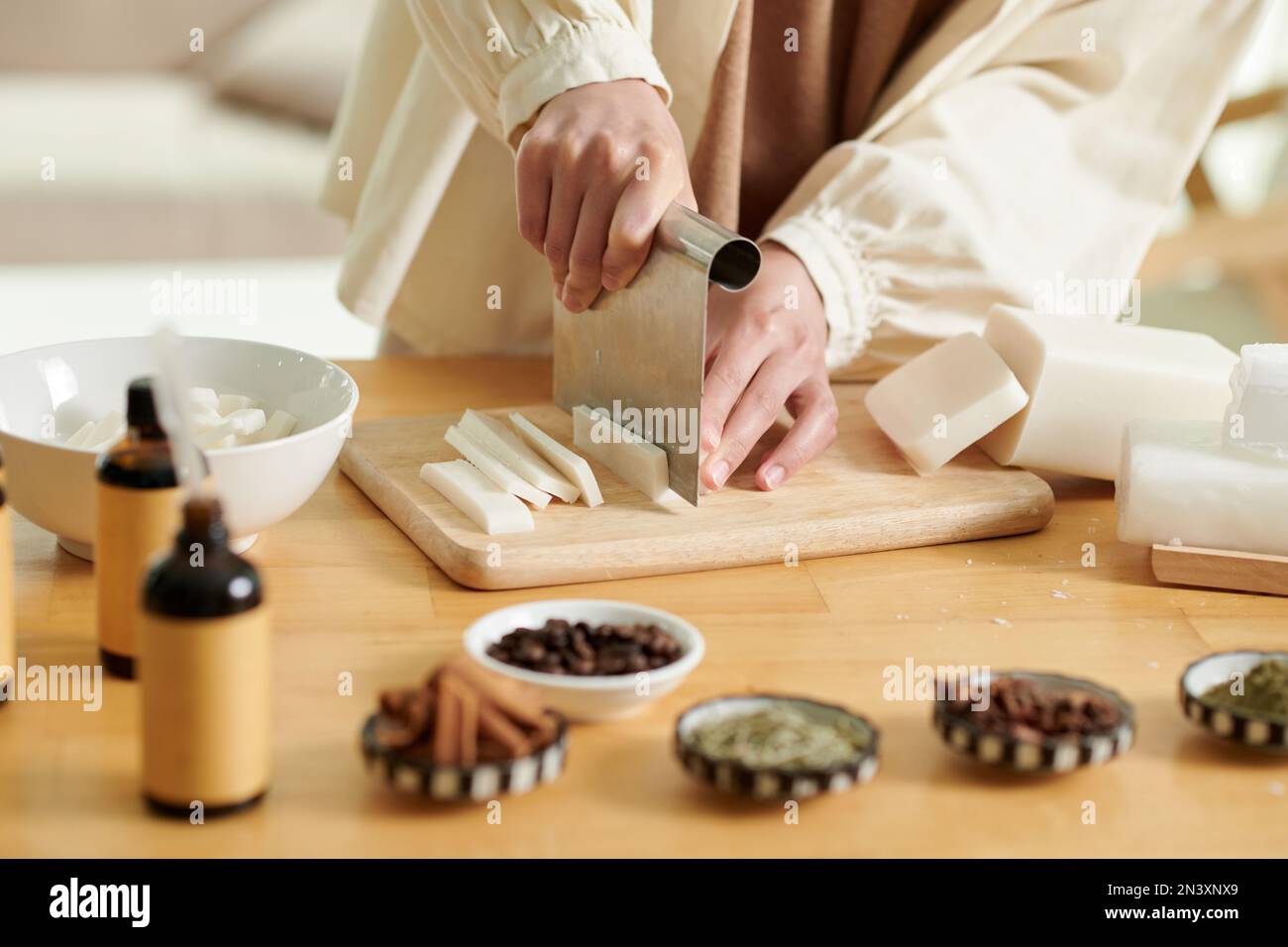 A soap-maker weighs aromatic oils for making cosmetics on a kitchen scale.  Home spa. Small business Stock Photo - Alamy