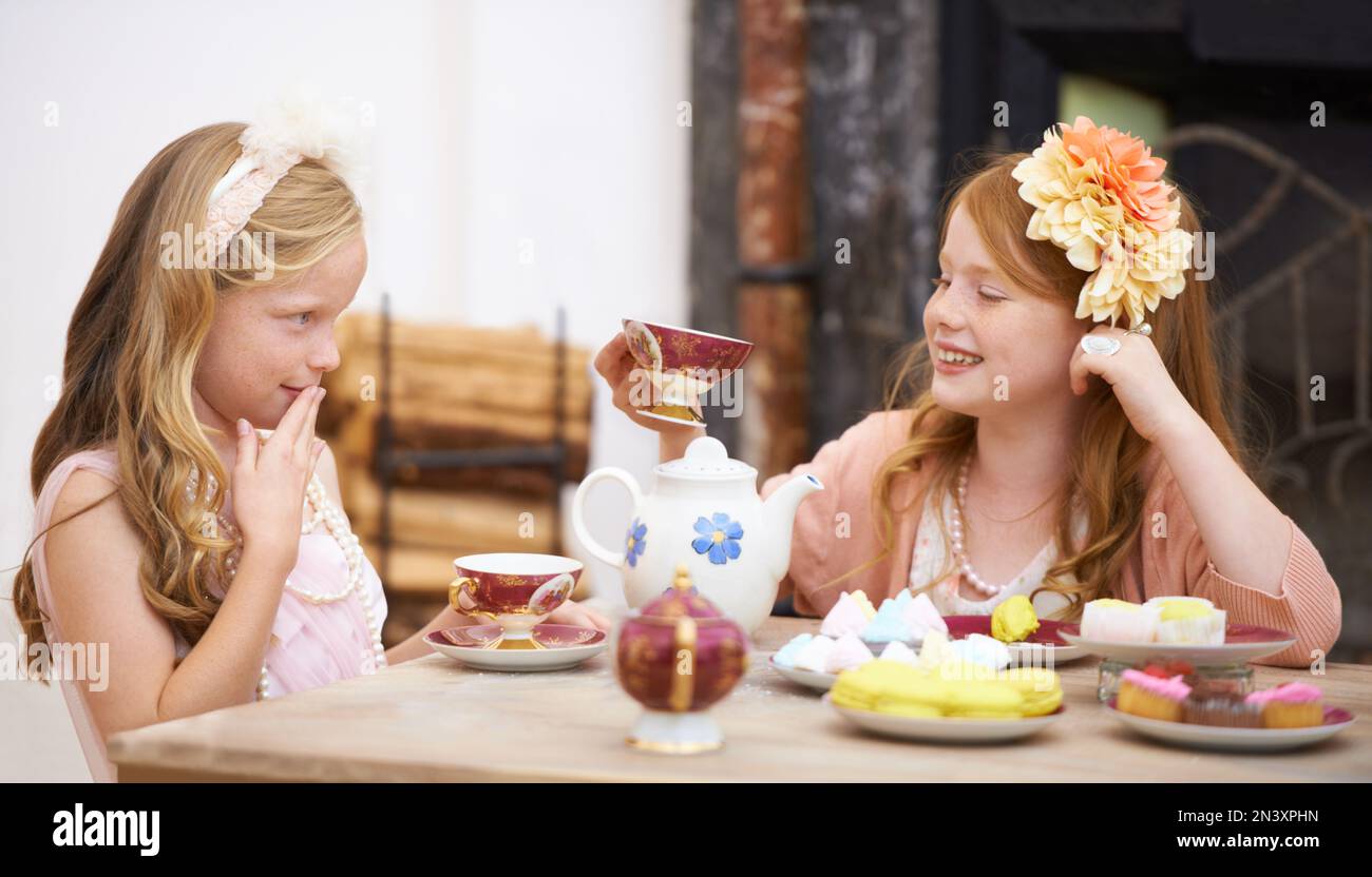 Its tea time. Two friends dressing up and having a tea party outside in ...