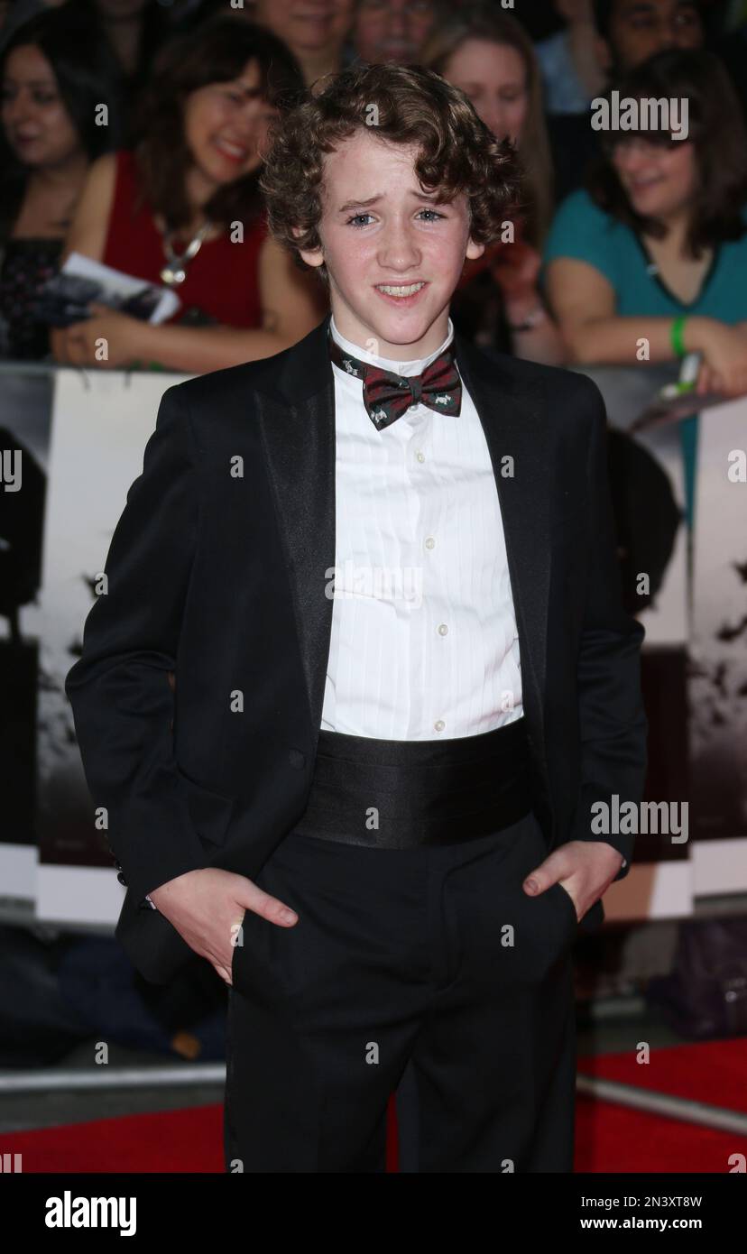 Art Parkinson poses for photographers as they arrive for the premiere