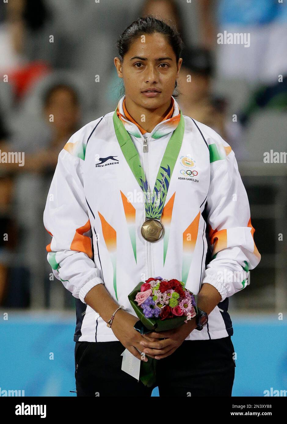Sunita Rani India's Annu Rani cstands on the podium after receiving her bronze ...
