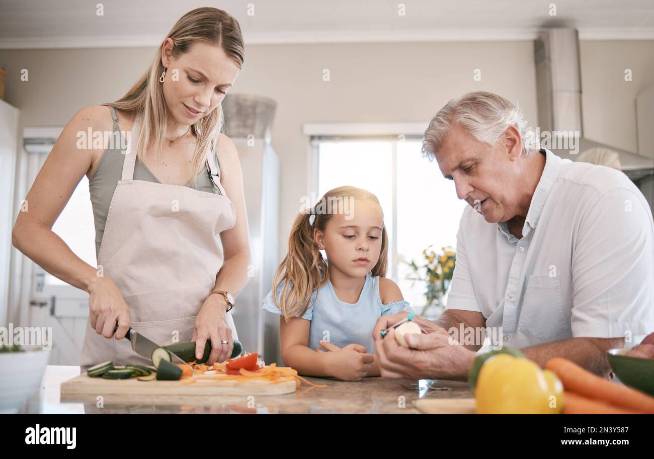 Family home, cooking a vegetables with a child helping mother and ...