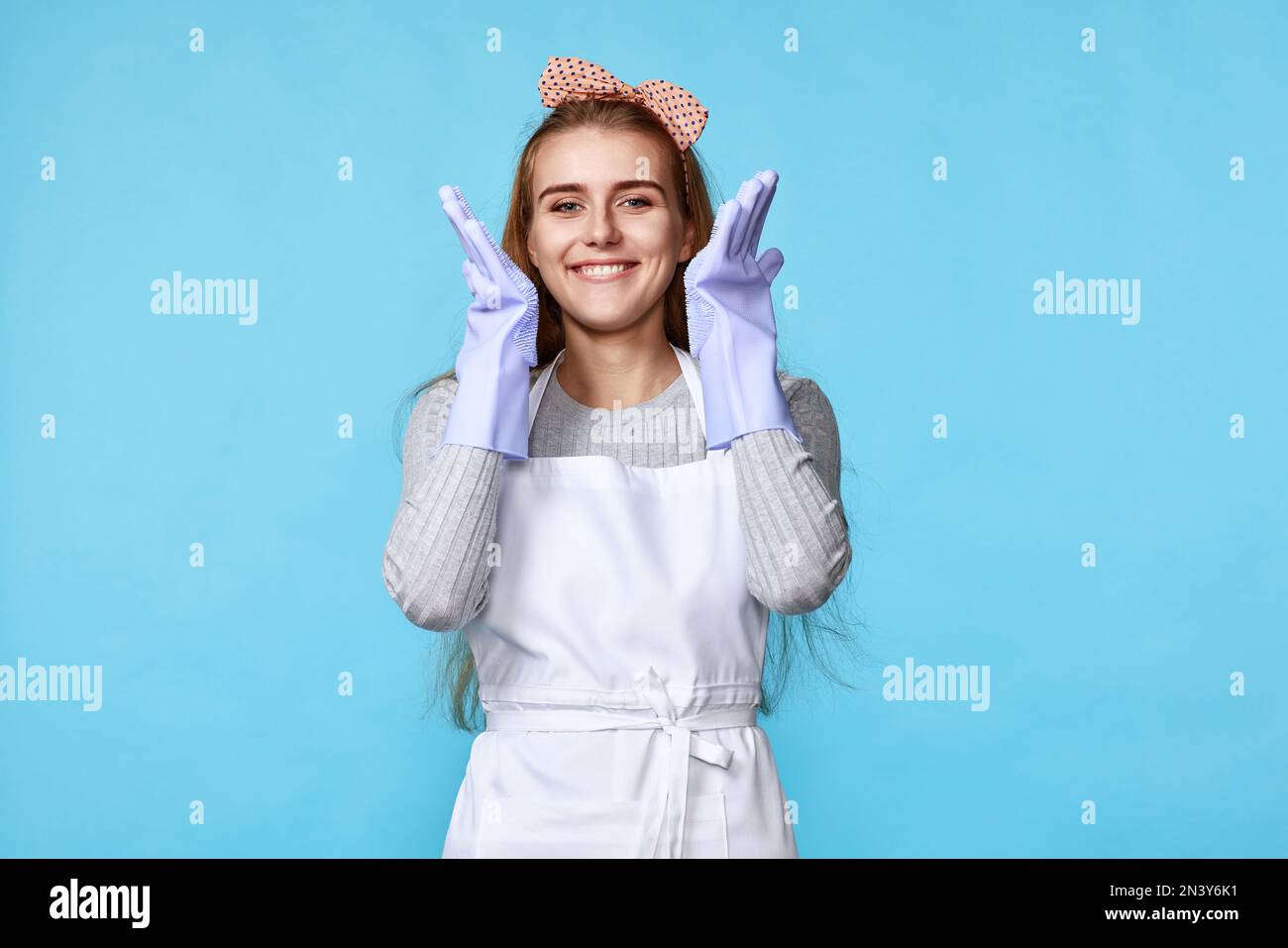 woman in rubber gloves and cleaner apron looking at camera Stock Photo ...