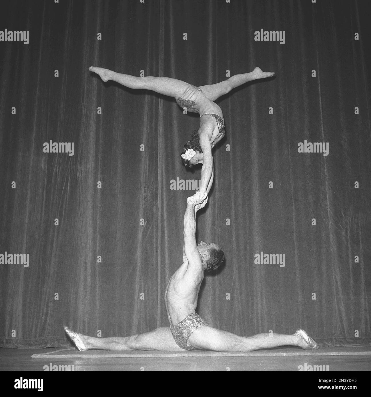 1940s acrobatic show. The three acrobats practice their balance act ...