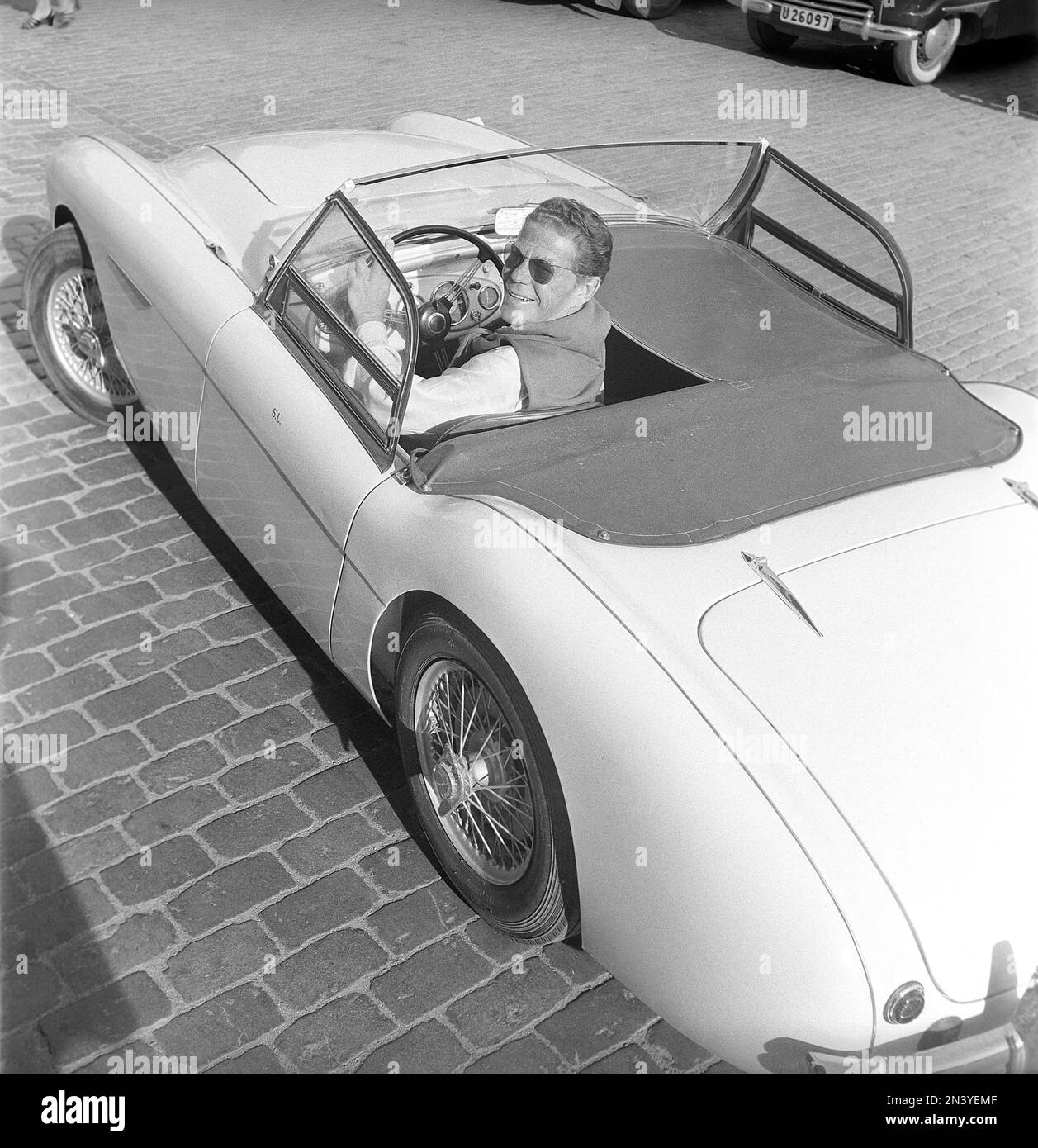 Driving in the 1950s. Actor Sture Lagerwall in his British Austin-Healey 100-6, a convertible. Sweden 1953. ref BL108-9 Stock Photo