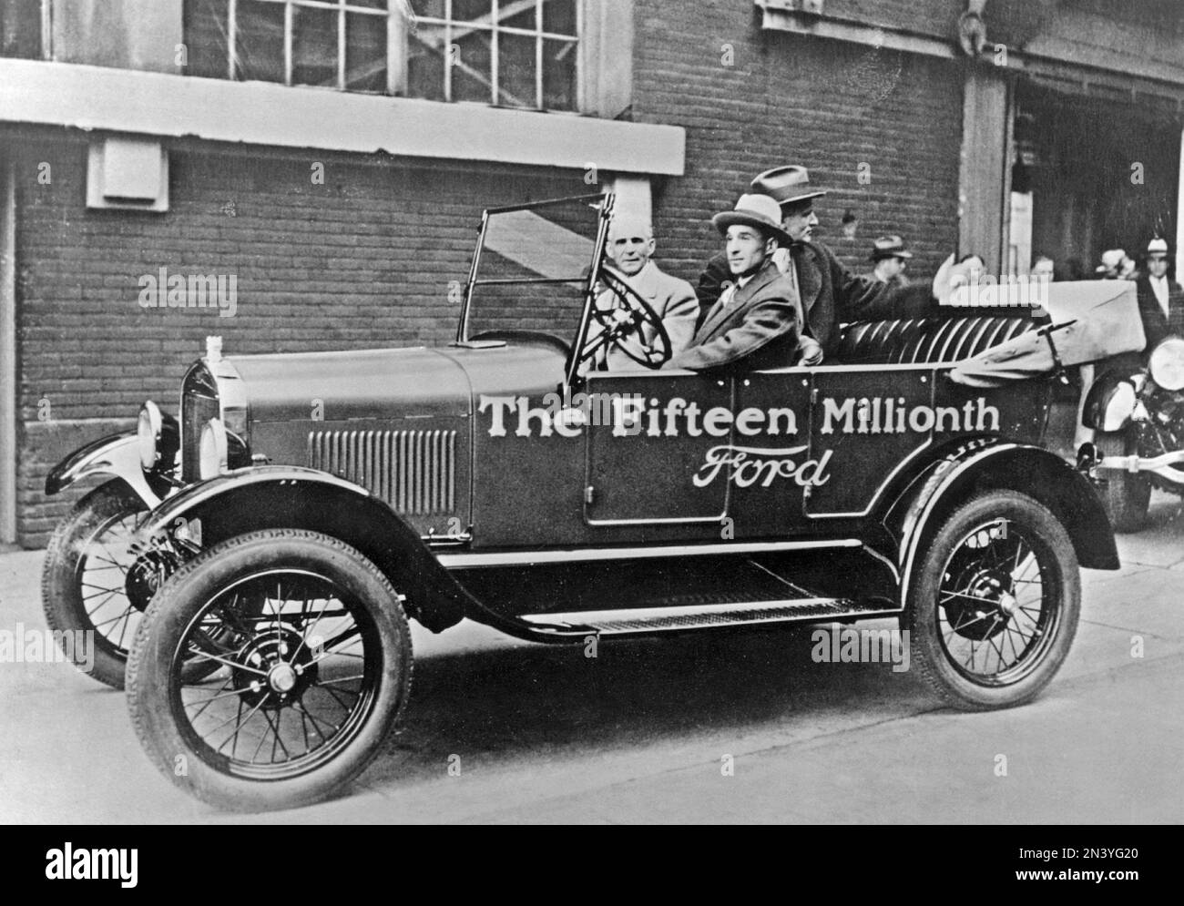 Ford history. The fifteen millionth Ford car ready. The event is marked by that Henry Ford and his son Edsel is pictured in the car when it's out of the production line at the Ford car factory 1927. Stock Photo