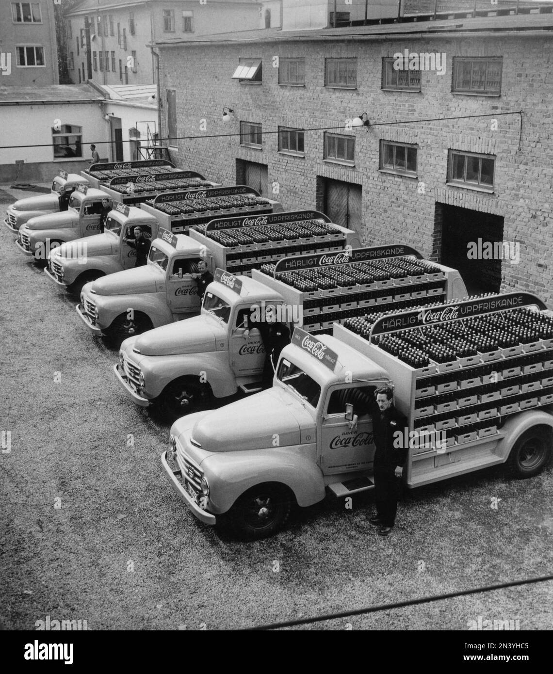 Coca cola in the 1950s. In 1 january 1953 Coca-Cola was first allowed to be manufactured and sold in Sweden, previously being restricted from sales in Sweden since the content of Coca-cola included forbidden substances like phosphoric acid and caffeine. Overview of the first  distribution trucks of the brewery Mineralvattenfabriken Tre Kronor loaded with Coca-Cola bottles. Volvo trucks model L34 modifyed and painted in red for the exclusive use on Coca-Cola trucks. Coca-Cola was early with having advertising on their vehicles. Sweden 1953 Stock Photo