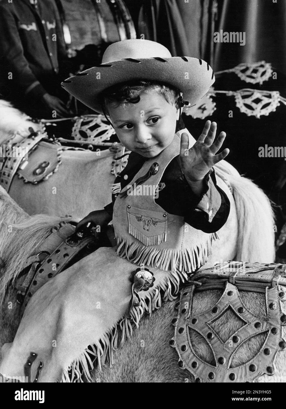 In the 1960s. A boy on a horse dressed in cowboy clothes and hat. Sweden 1964 Stock Photo