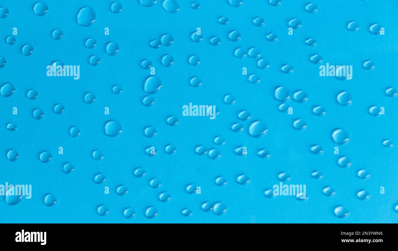 A water drop on a blue background. Stock Photo