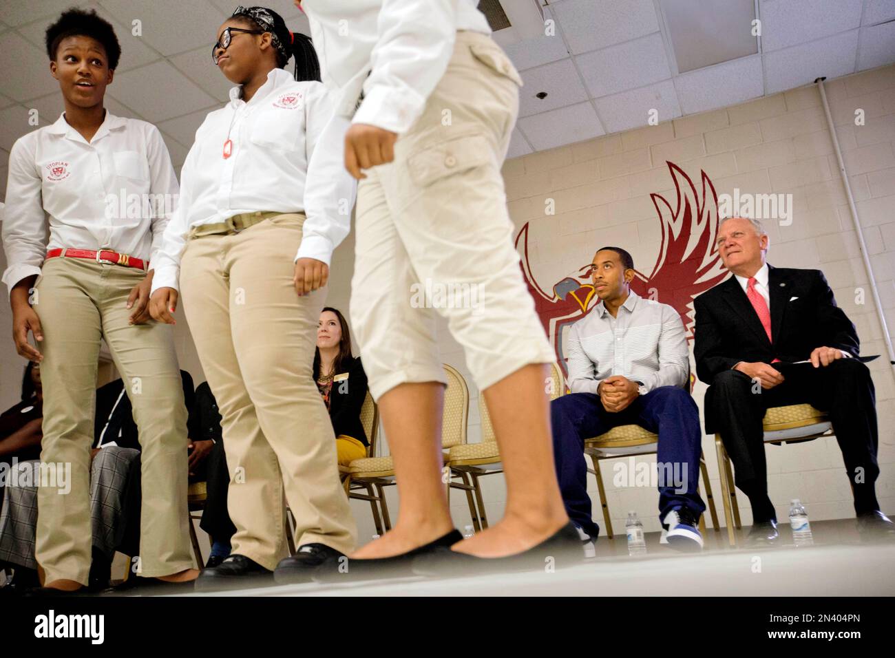 Rapper Ludacris, rear left, and Georgia Gov. Nathan Deal watch a skit performed by charter school students at Utopian Academy for the Arts, Friday, Sept. 26, 2014, in Riverdale, Ga. Deal and Ludacris may seem like an odd pairing for a campaign event, but the duo was a hit with a cheering crowd of students Friday. Christopher "Ludacris" Bridges has been an outspoken supporter of President Barack Obama, penning a profane song during the 2008 campaign criticizing his opponents. But Deal says he couldn't think of anyone better to inspire students at the event. (AP Photo/David Goldman) Stock Photo
