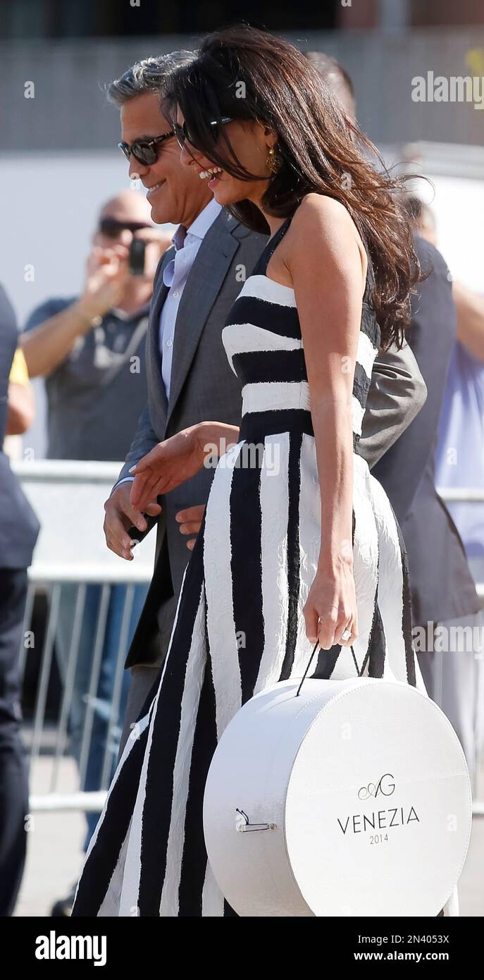 George Clooney and Amal Alamuddin arrive in Venice, Italy, Friday, Sept.  26, 2014. George Clooney and his fiancee Amal Alamuddin have arrived in  Venice for their weekend wedding extravaganza. A clutch of