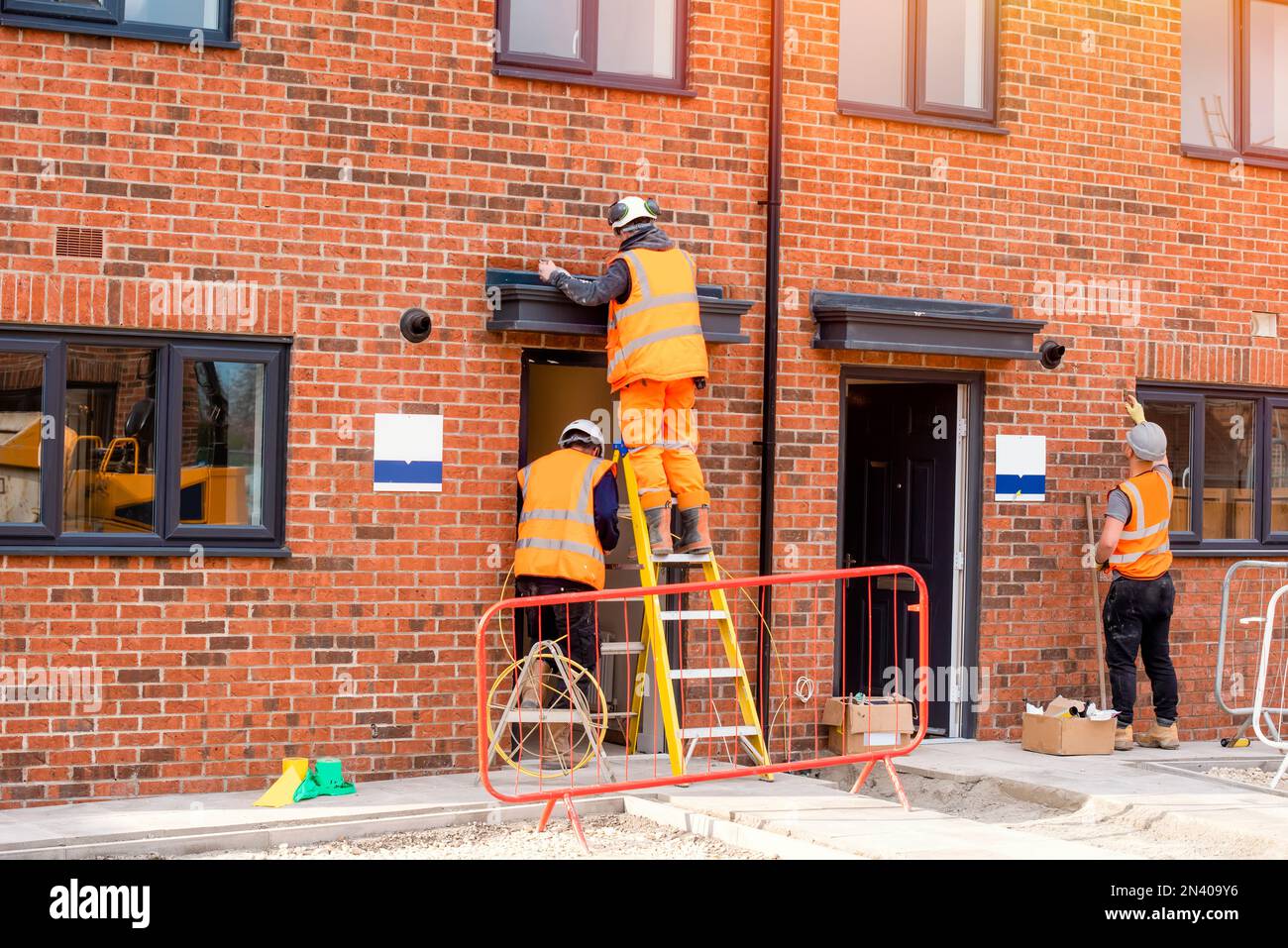 Construction site builder climbing on the ladder on working on hight Stock Photo