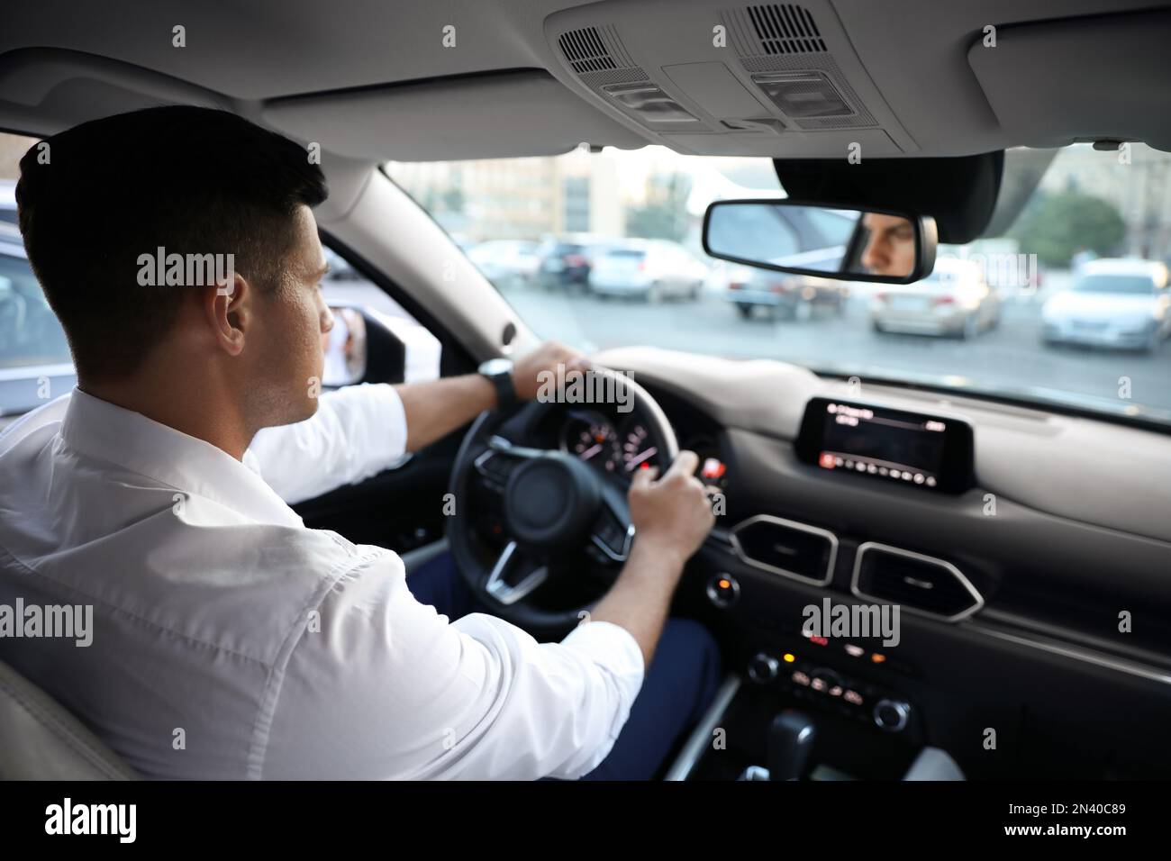 Man driving his modern luxury car, view from backseat Stock Photo Alamy